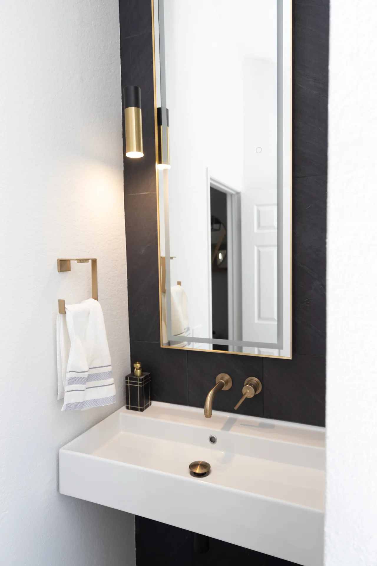 Whole-home remodel — bath vanity with wall-mount brass faucet, Orange, Avorino