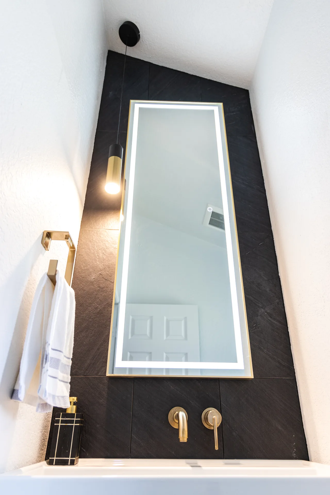 Whole-home remodel — bath with tall lit mirror on slate tile, Orange, Avorino