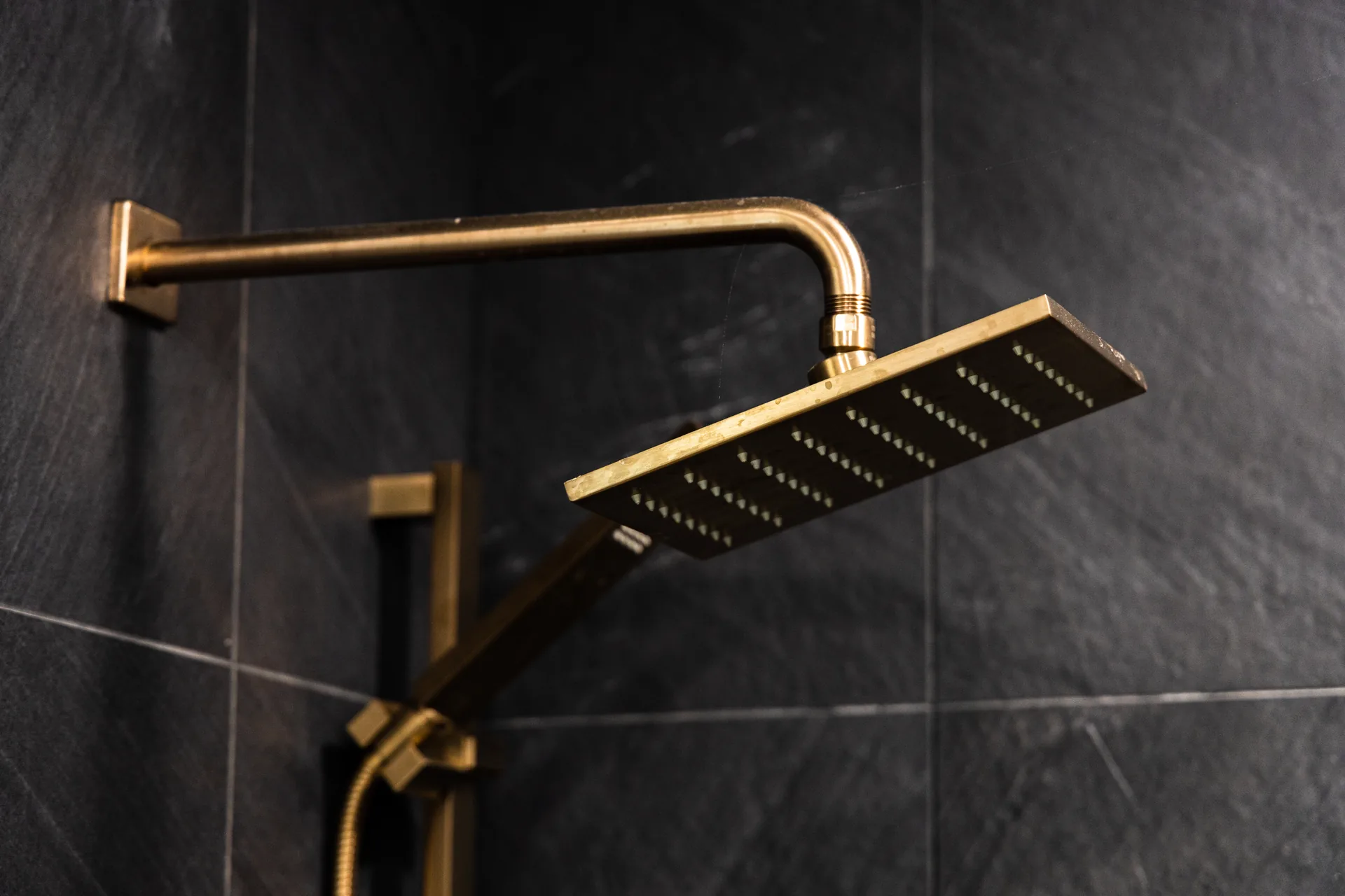Whole-home remodel — brass rain shower head detail, Orange, Avorino