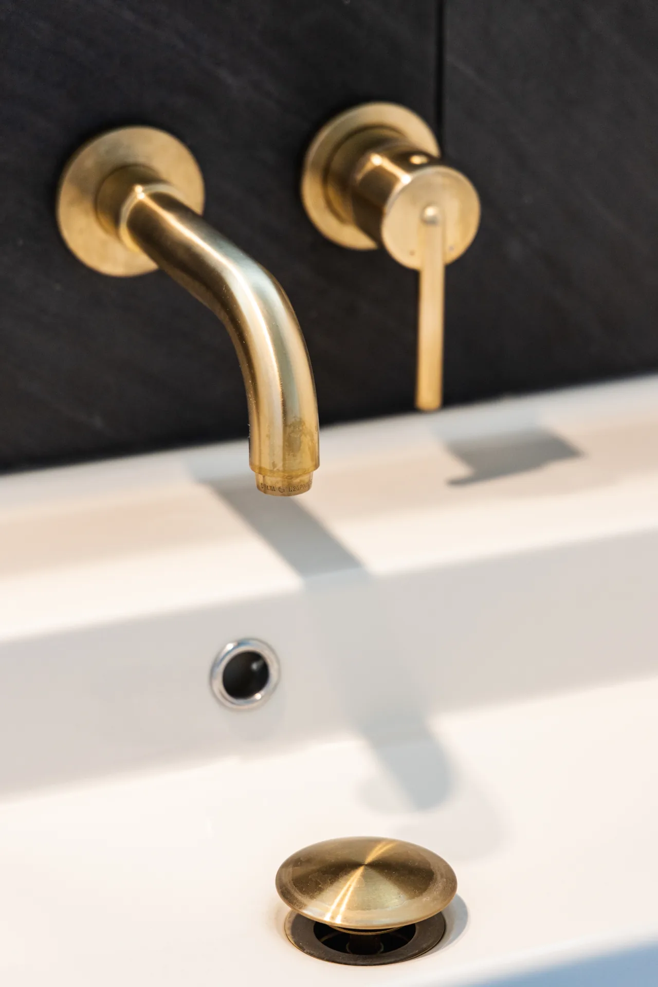 Whole-home remodel — bath, wall-mount brass faucet detail, Orange, Avorino