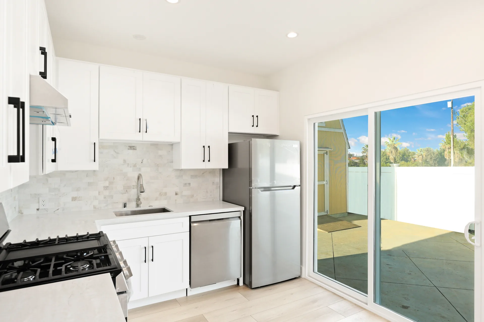 Garage conversion ADU — kitchen with slider to the yard, Brea, Avorino