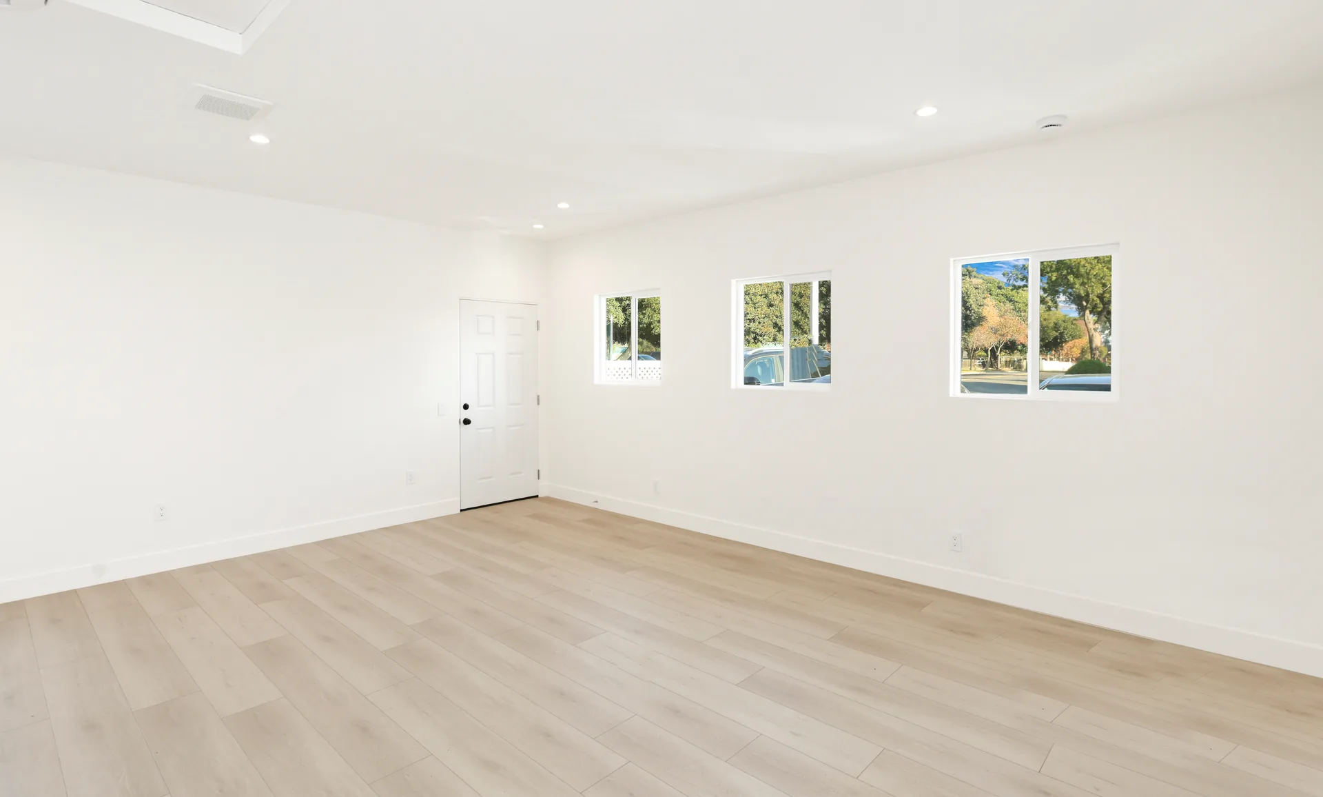 Garage conversion ADU — studio room with three windows, Brea, Avorino