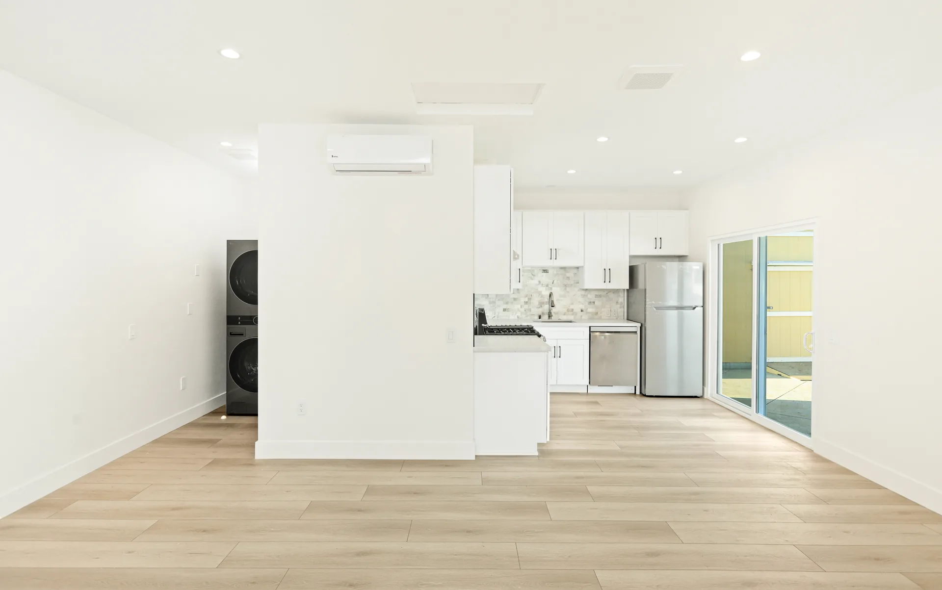 Garage conversion ADU — kitchen and laundry from the living area, Brea, Avorino