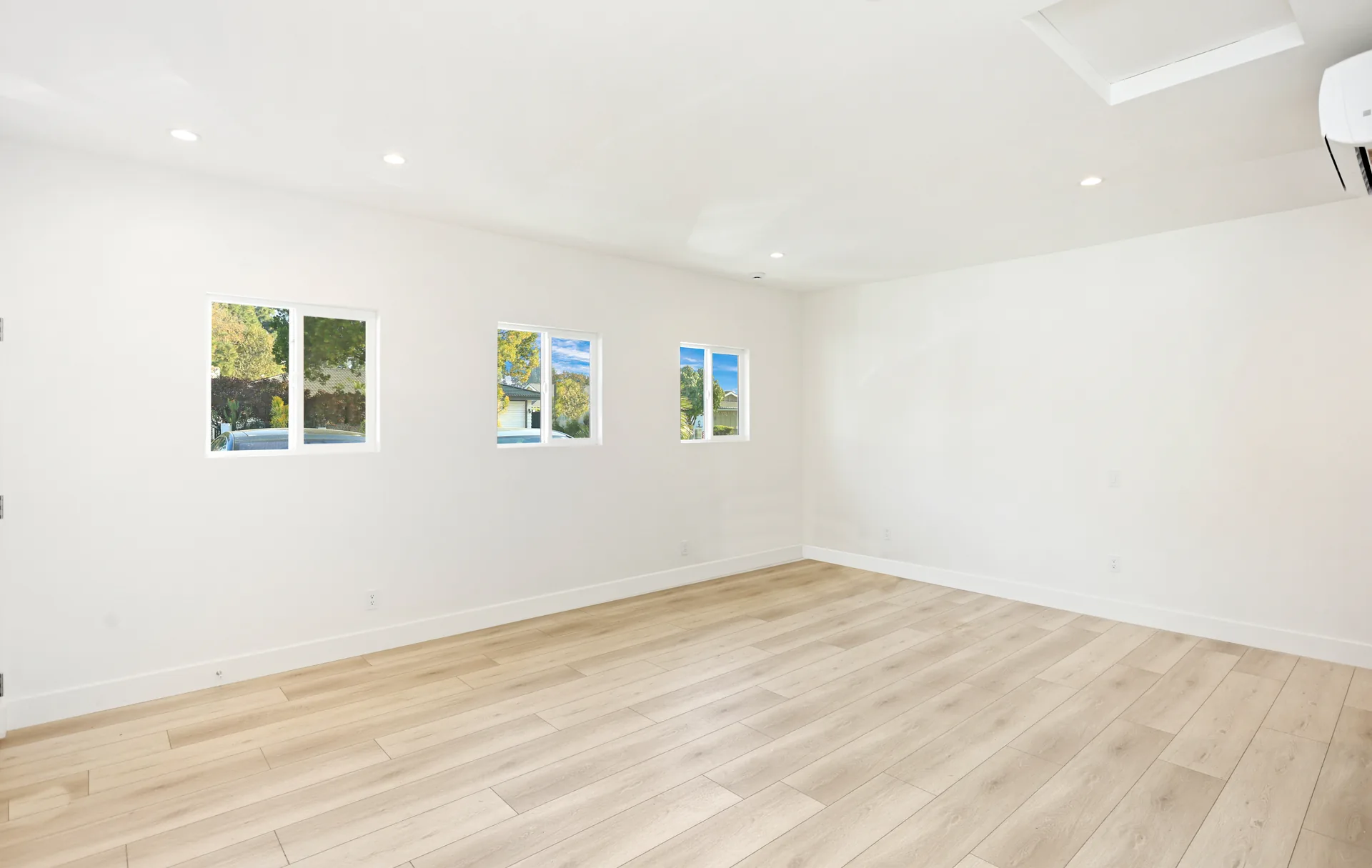 Garage conversion ADU — main room with three windows, Brea, Avorino