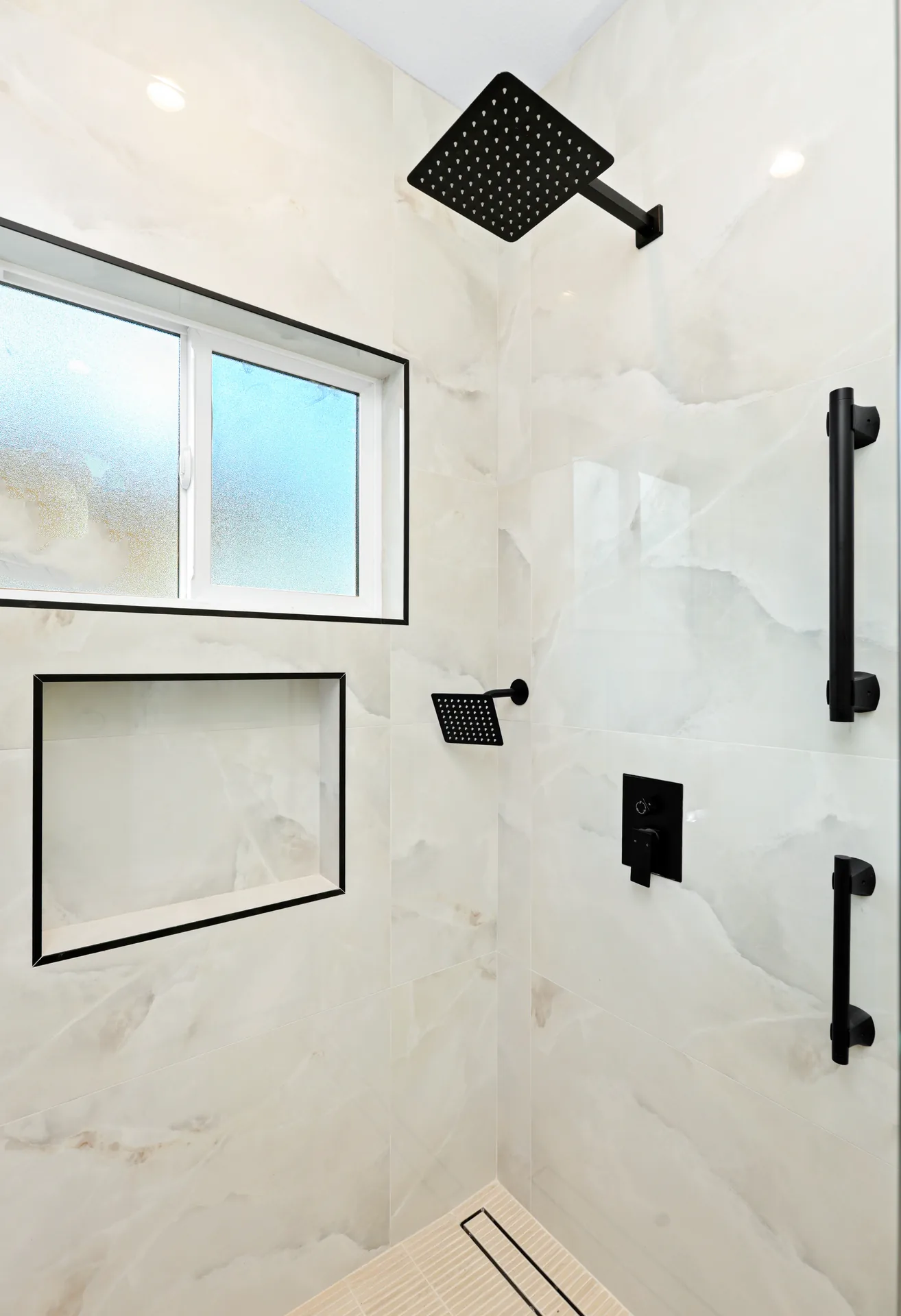 Garage conversion ADU — walk-in shower with matte-black fixtures, Brea, Avorino