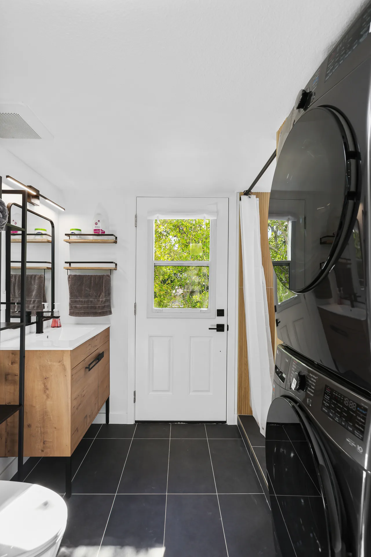 Two-story detached ADU — bath and laundry toward the entry, Santa Ana Hills, Avorino