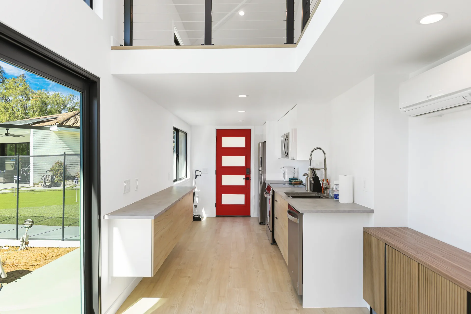 Two-story detached ADU — kitchen run to the red entry door, loft above, Santa Ana Hills, Avorino