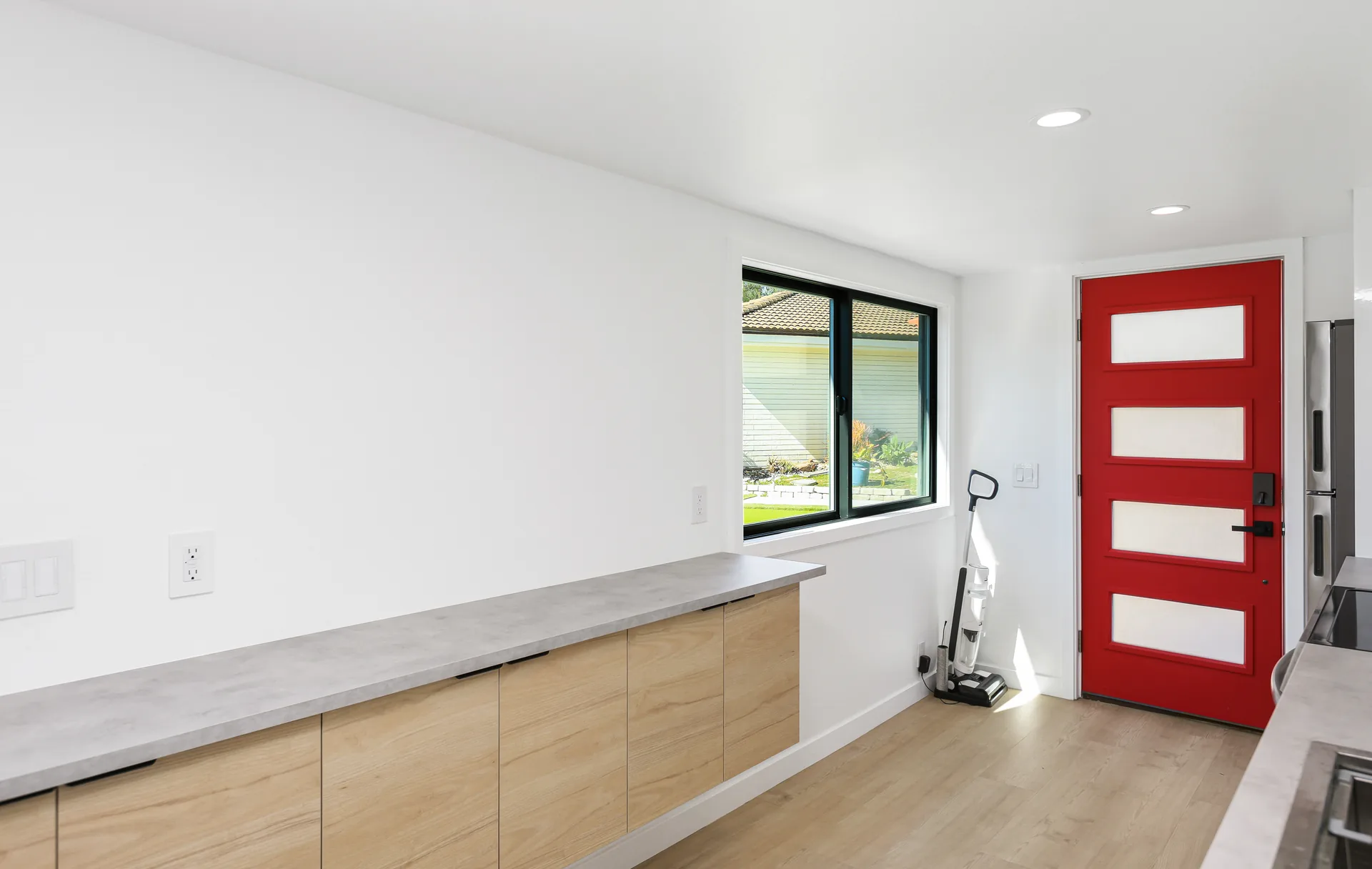 Two-story detached ADU — kitchen counter and red entry door, Santa Ana Hills, Avorino