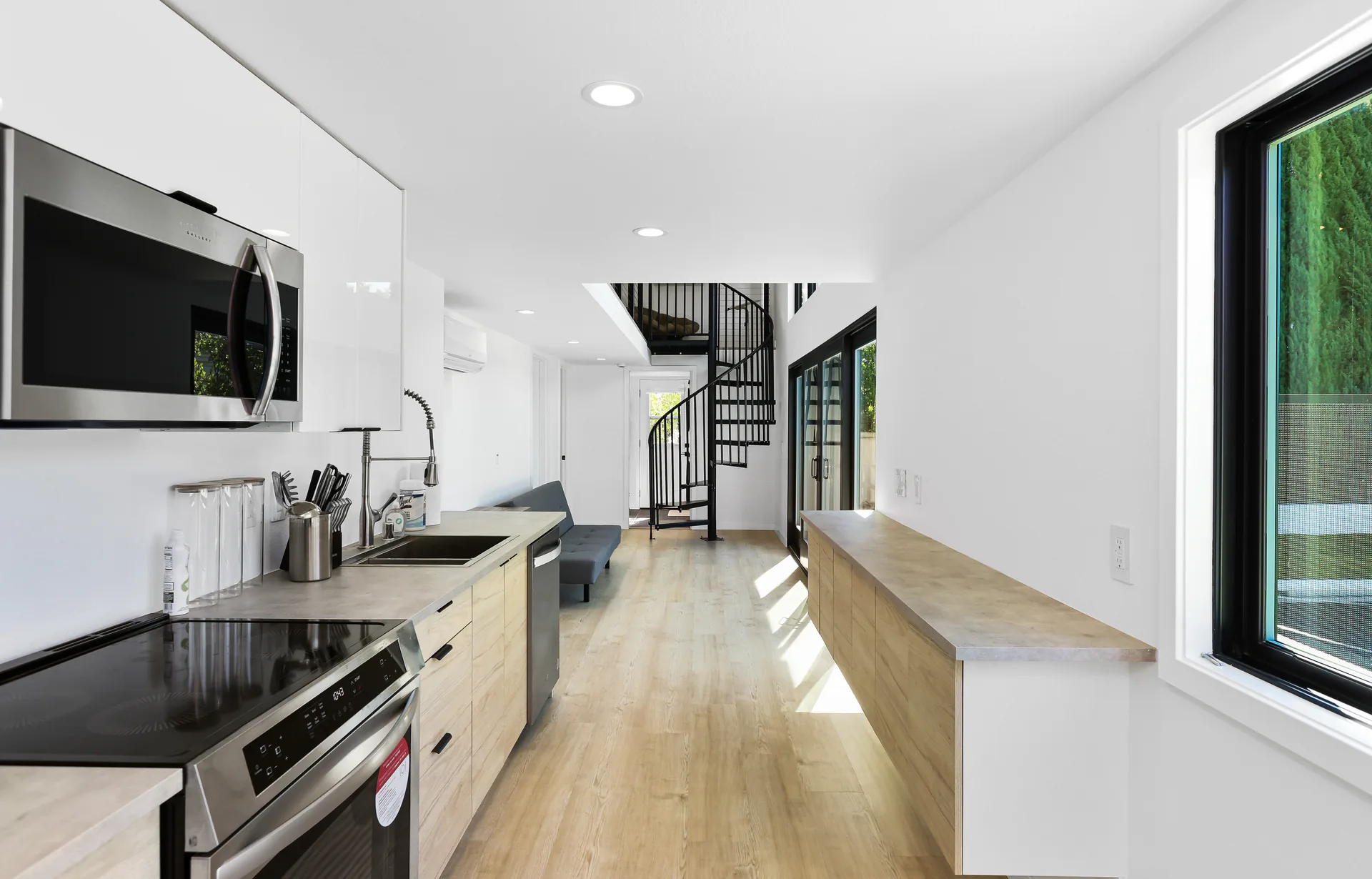 Two-story detached ADU — galley kitchen toward the spiral stair, Santa Ana Hills, Avorino