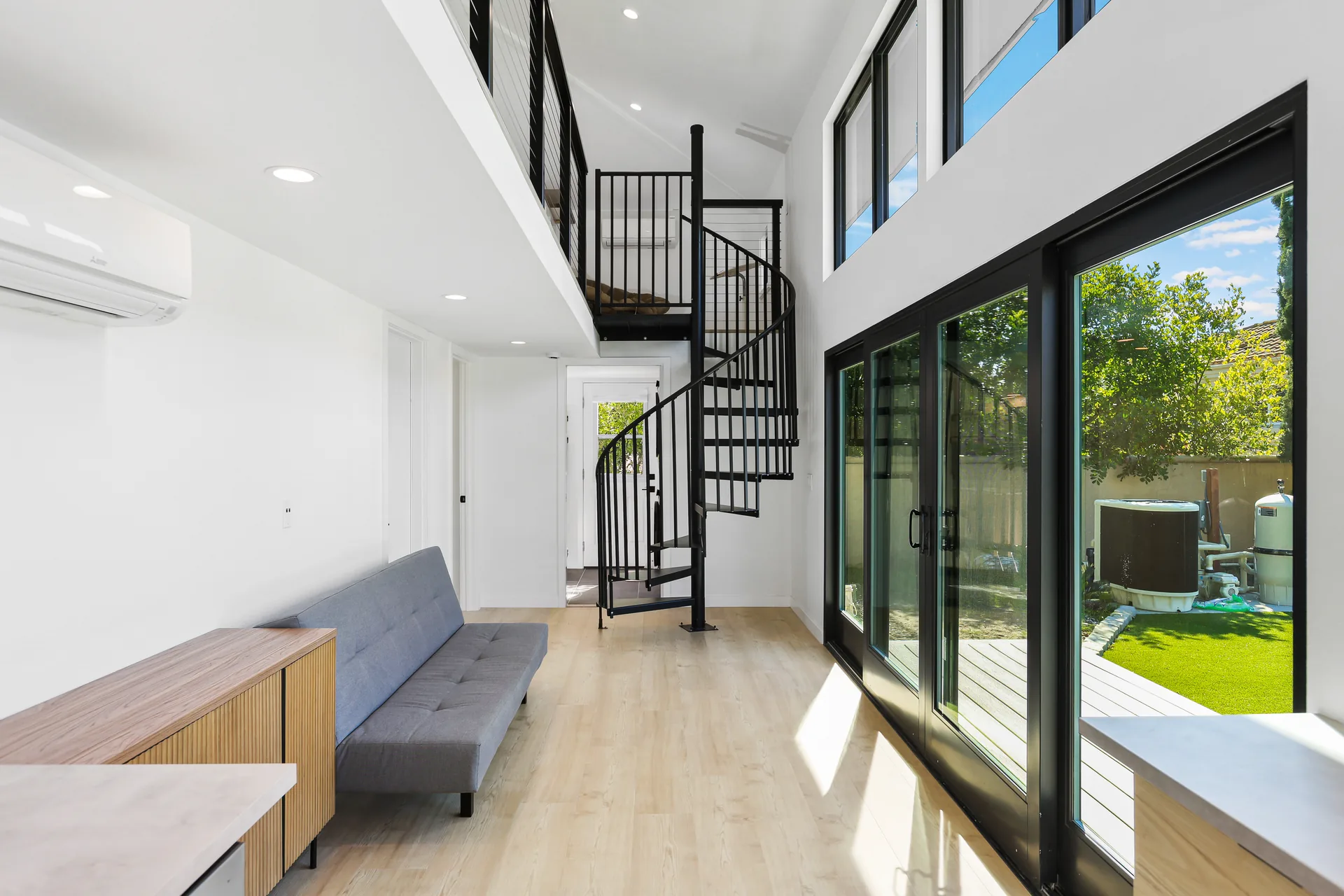 Two-story detached ADU — living room with spiral stair to the loft, Santa Ana Hills, Avorino