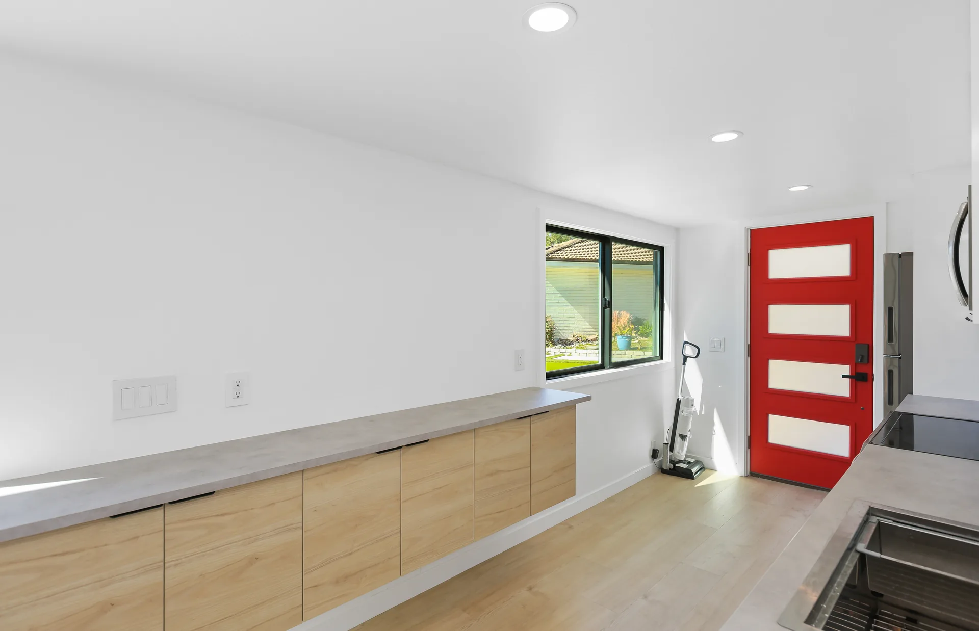 Two-story detached ADU — kitchen counter run and red entry door, Santa Ana Hills, Avorino