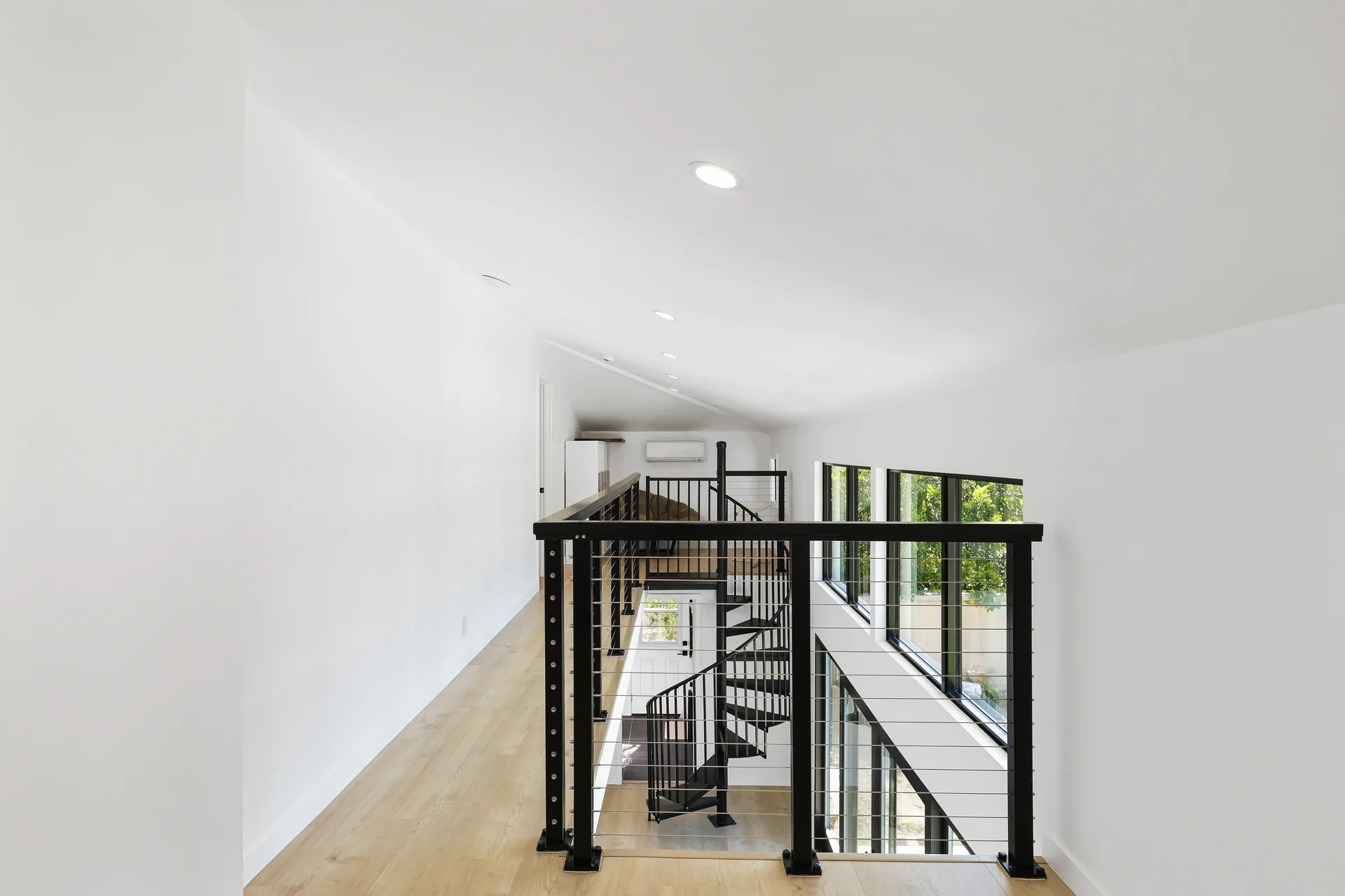 Two-story detached ADU — loft with cable-rail overlooking the living room, Santa Ana Hills, Avorino
