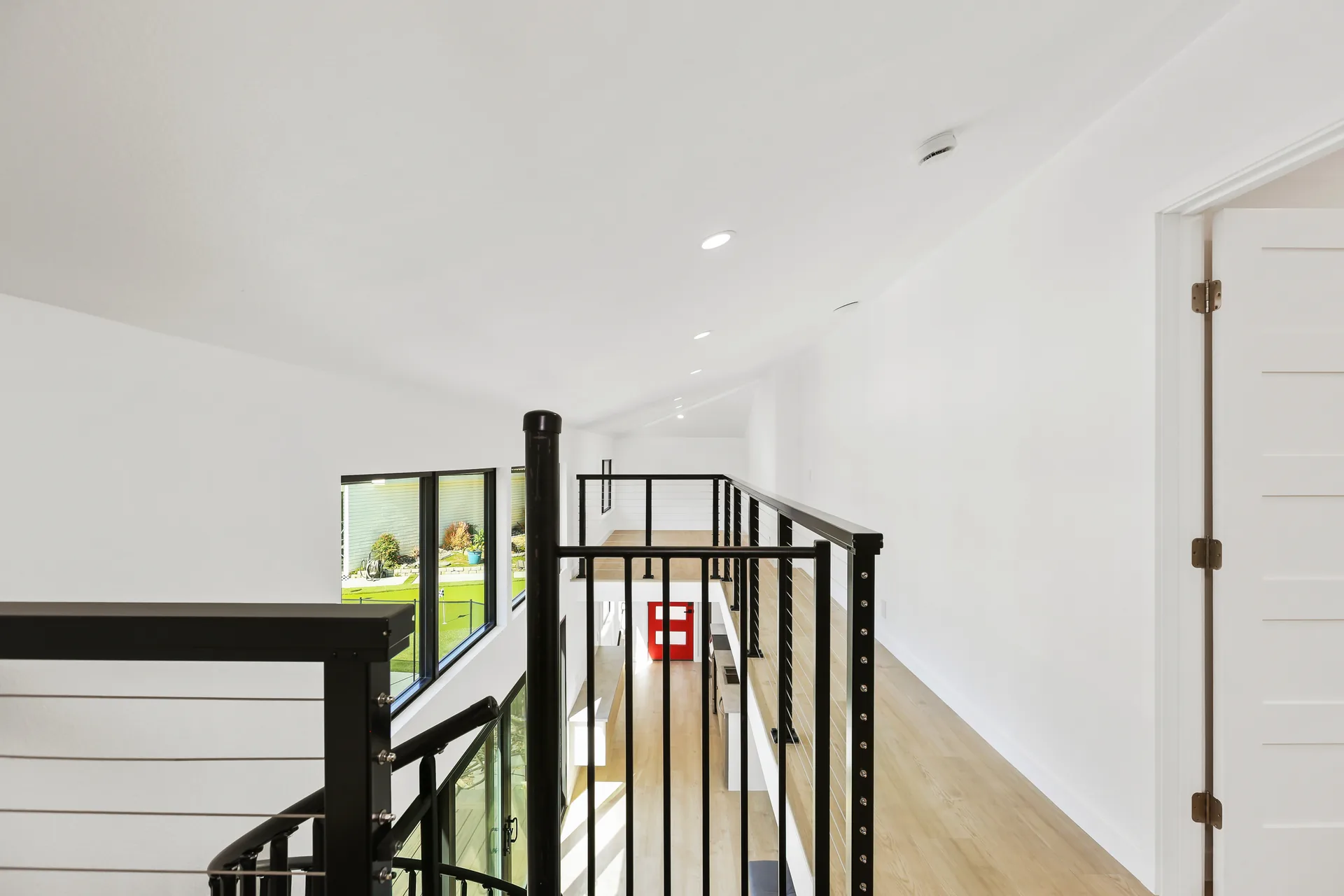 Two-story detached ADU — loft rail above the red entry door, Santa Ana Hills, Avorino