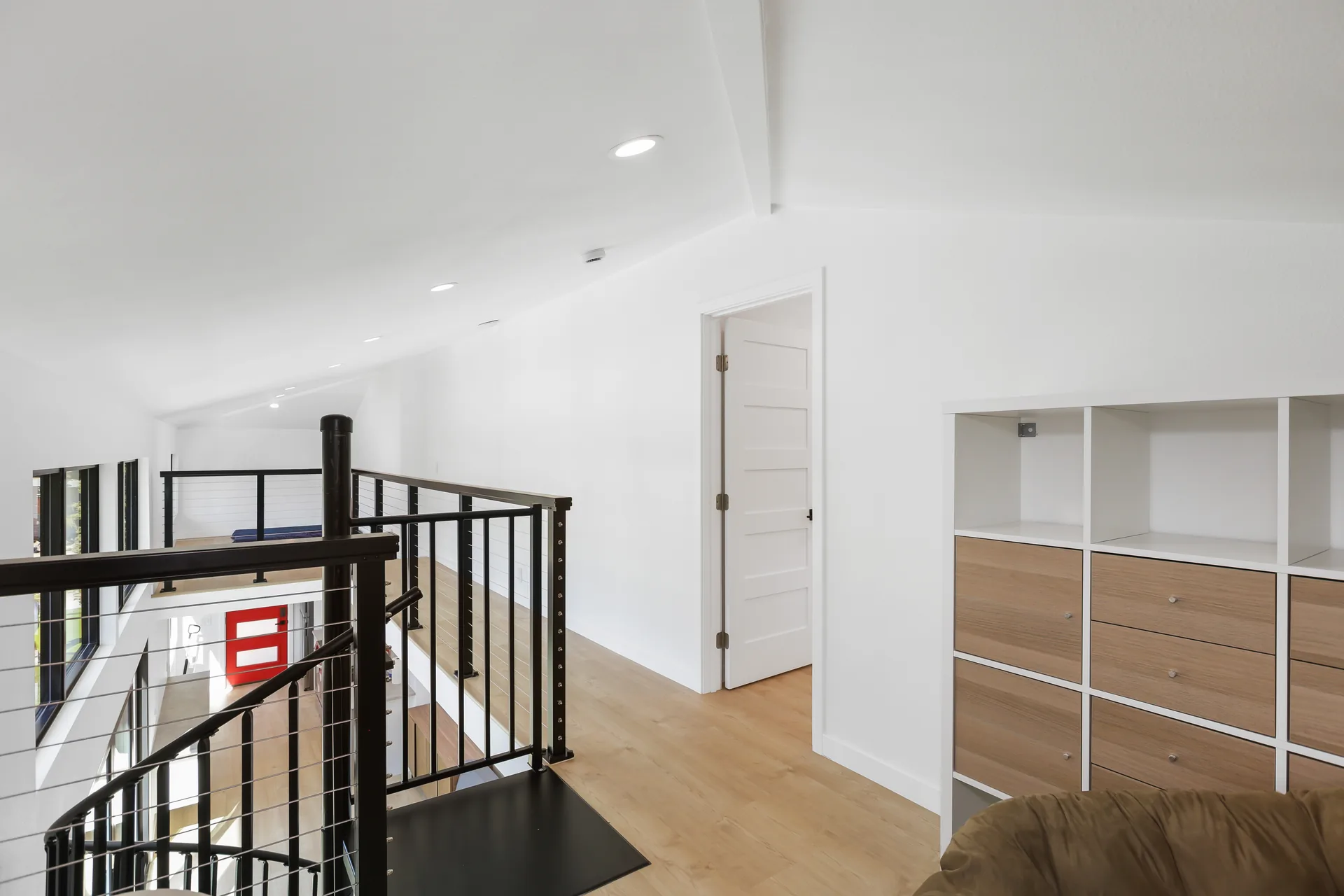 Two-story detached ADU — top of the spiral stair and built-in shelving, Santa Ana Hills, Avorino