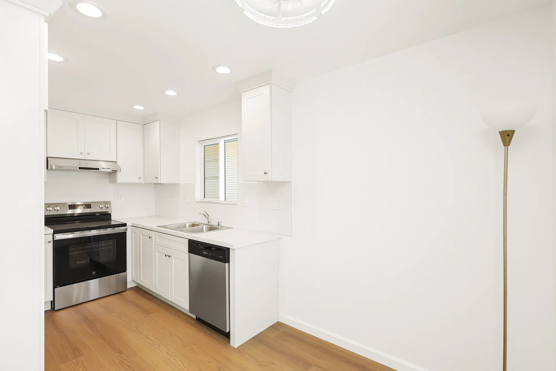 Detached ADU — kitchen run with white shaker cabinets and stainless range, Buena Park, Avorino