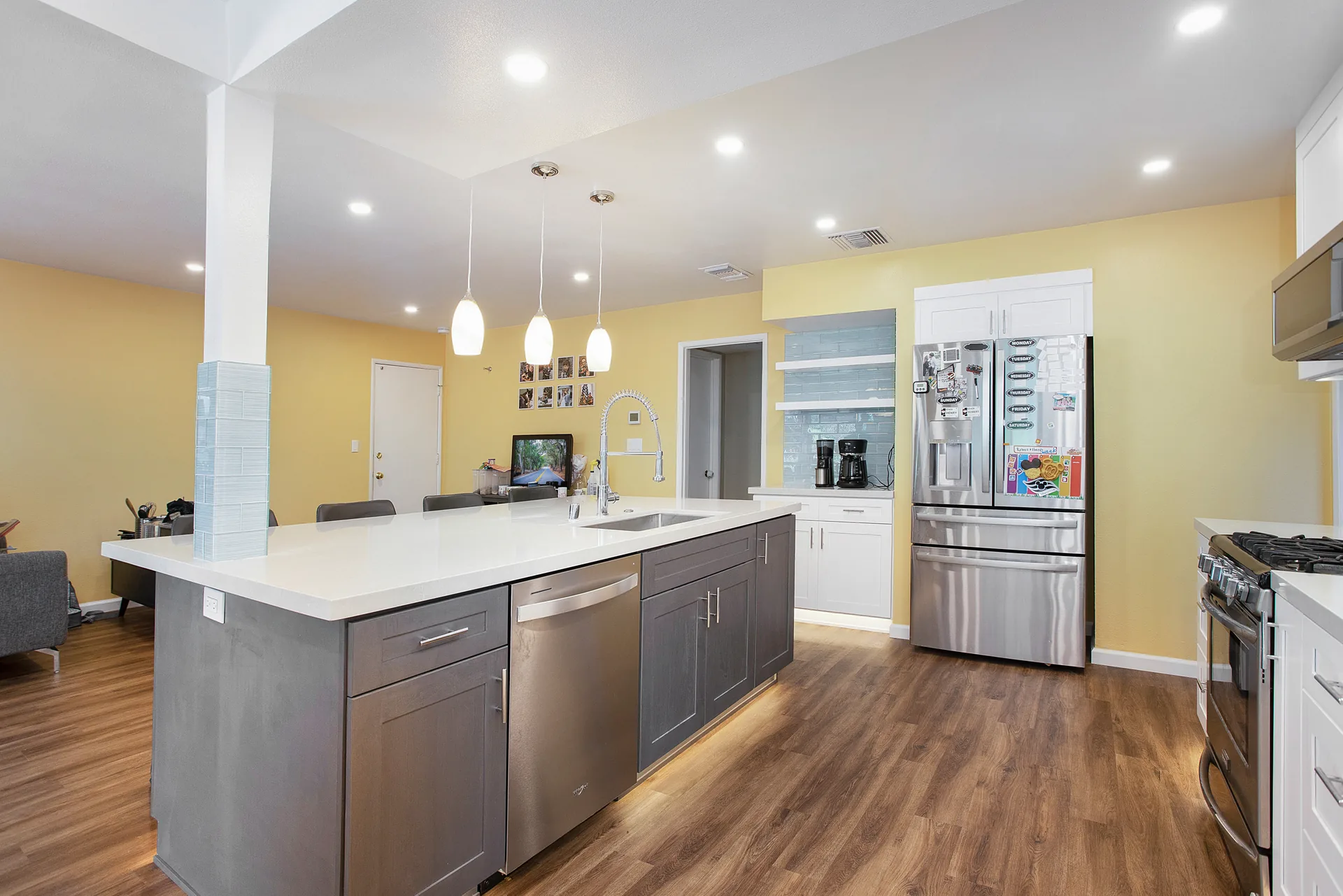 Open-concept kitchen remodel — island toward the fridge wall, Orange, Avorino