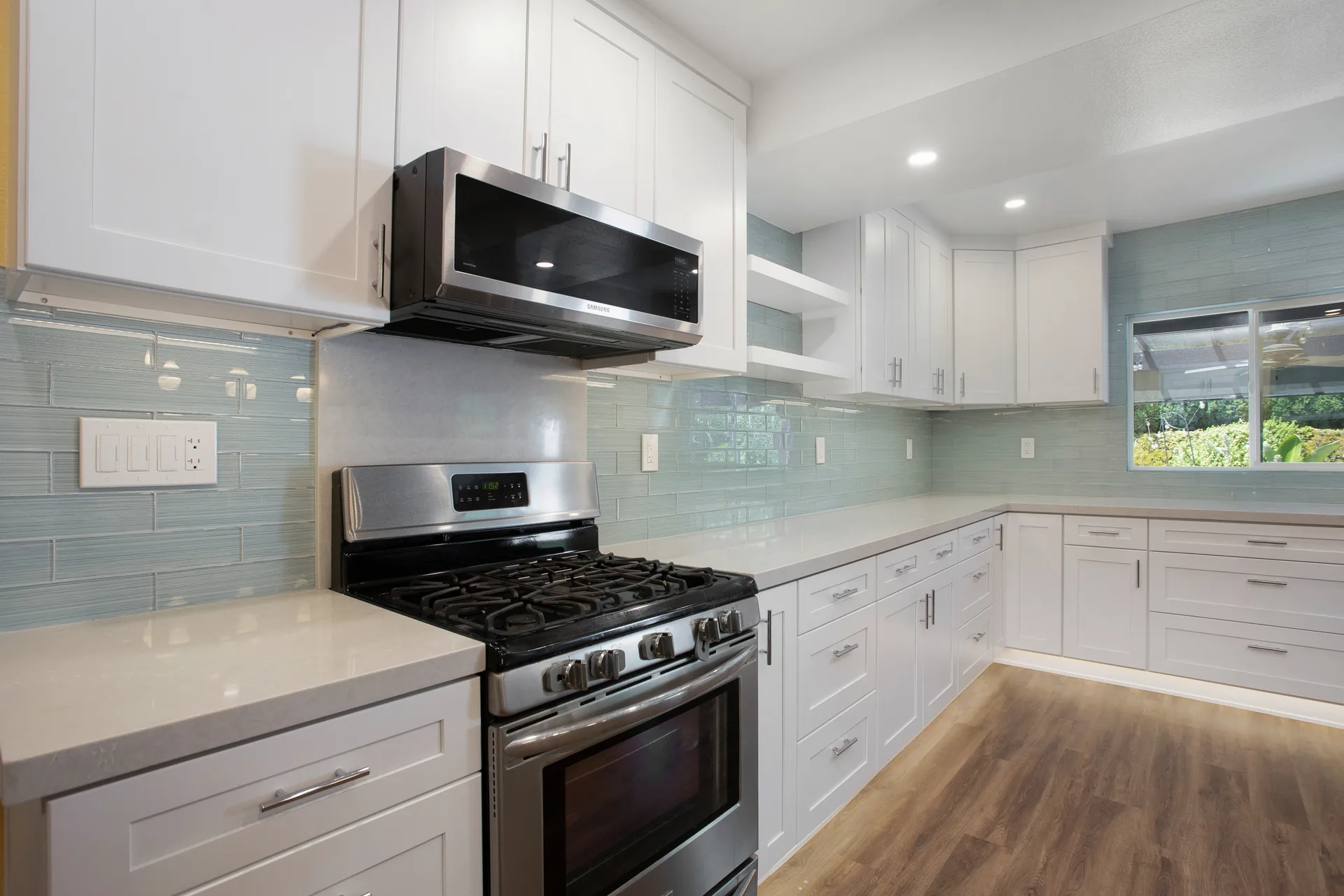 Open-concept kitchen remodel — range and microwave wall, Orange, Avorino