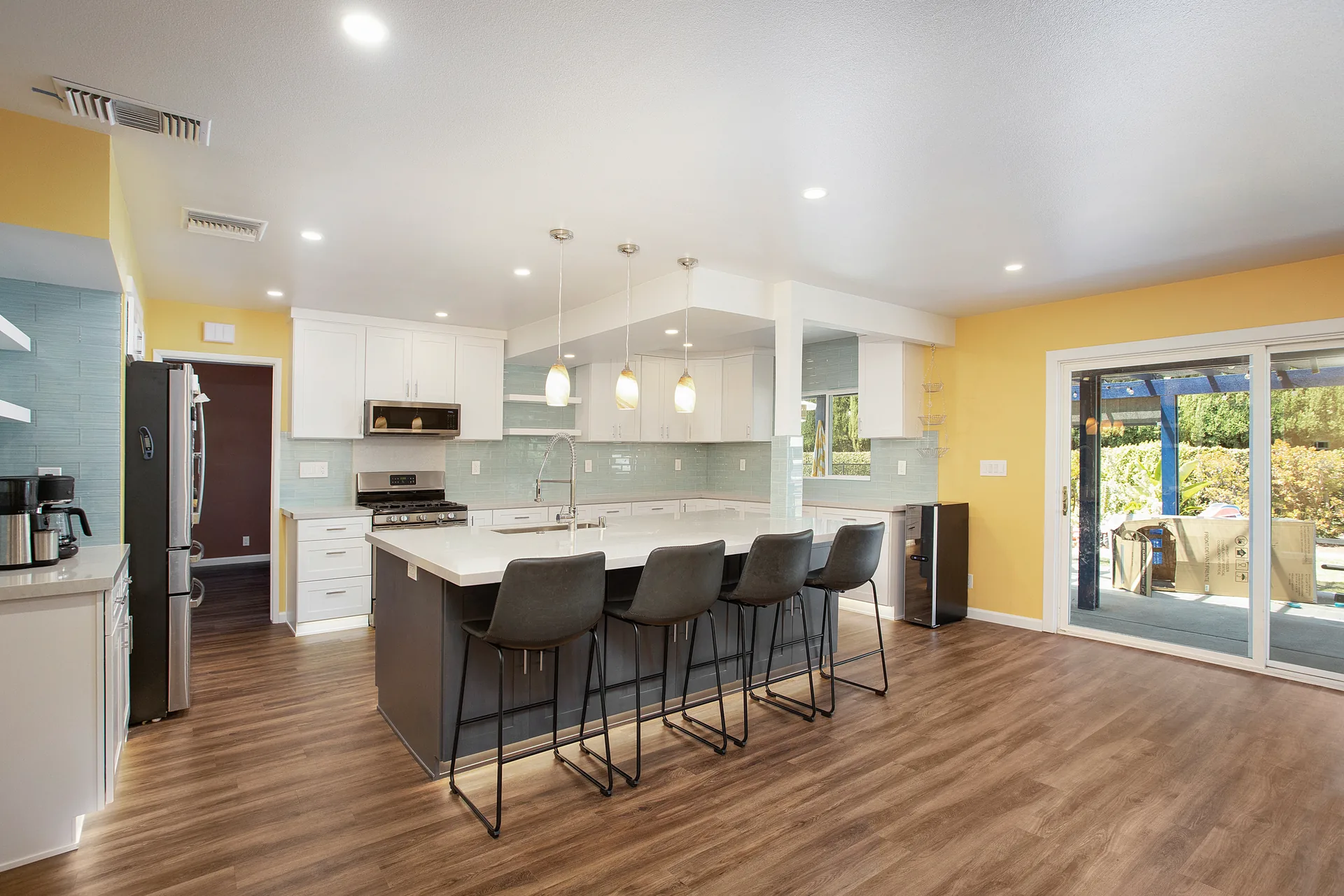 Open-concept kitchen remodel — island with seating and sliders to the yard, Orange, Avorino