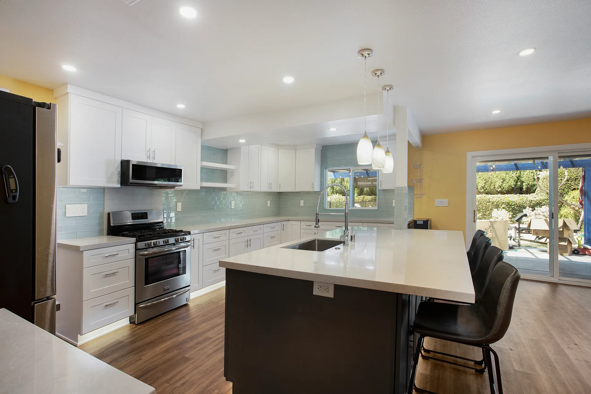 Open-concept kitchen remodel — range wall and island seating, Orange, Avorino
