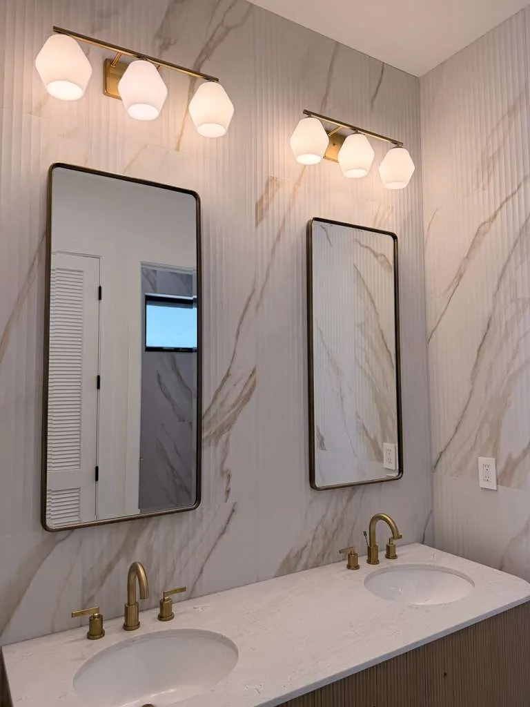 Custom pool house — double vanity with brass sconces, San Juan Capistrano, Avorino