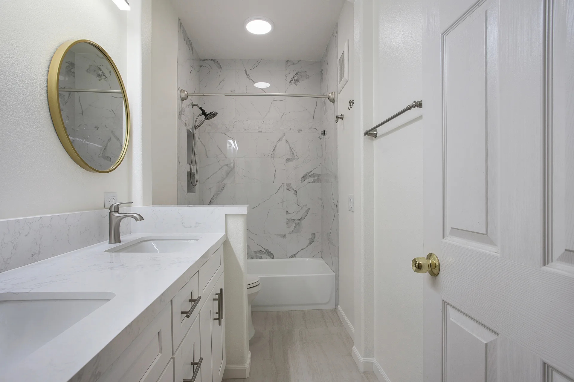 Primary bath renovation — double vanity and marble tub surround, Irvine, Avorino