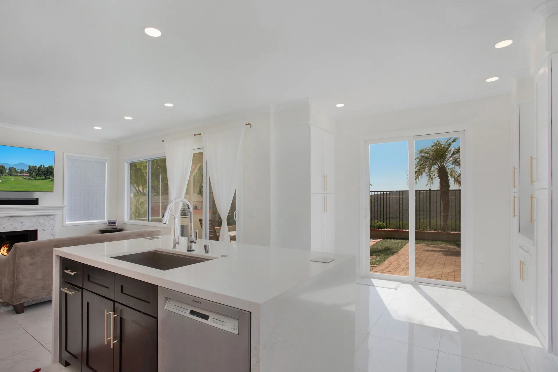 Custom home — island and sink with the yard beyond, Aliso Viejo, Avorino