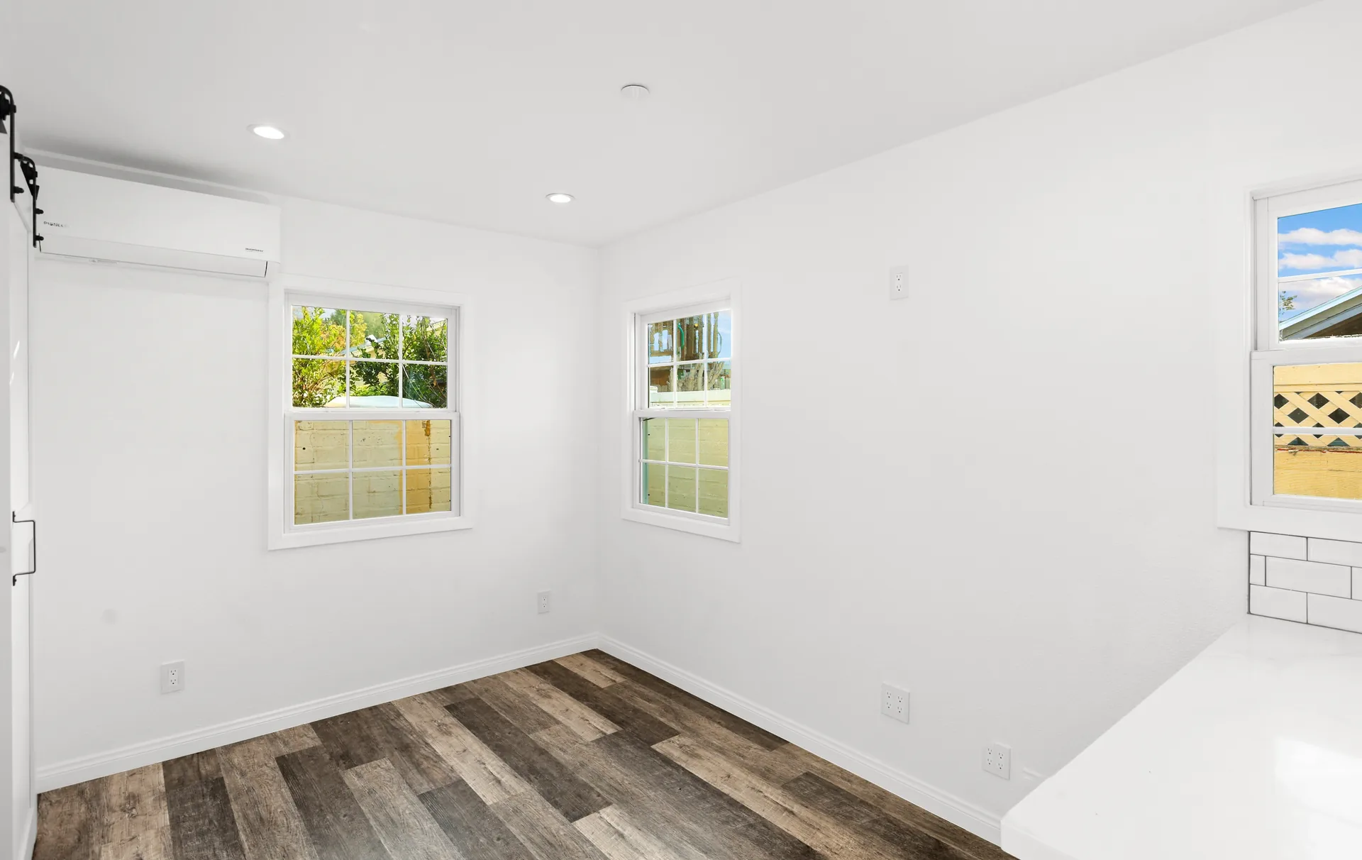 Attached ADU — bedroom with three windows, Orange, Avorino