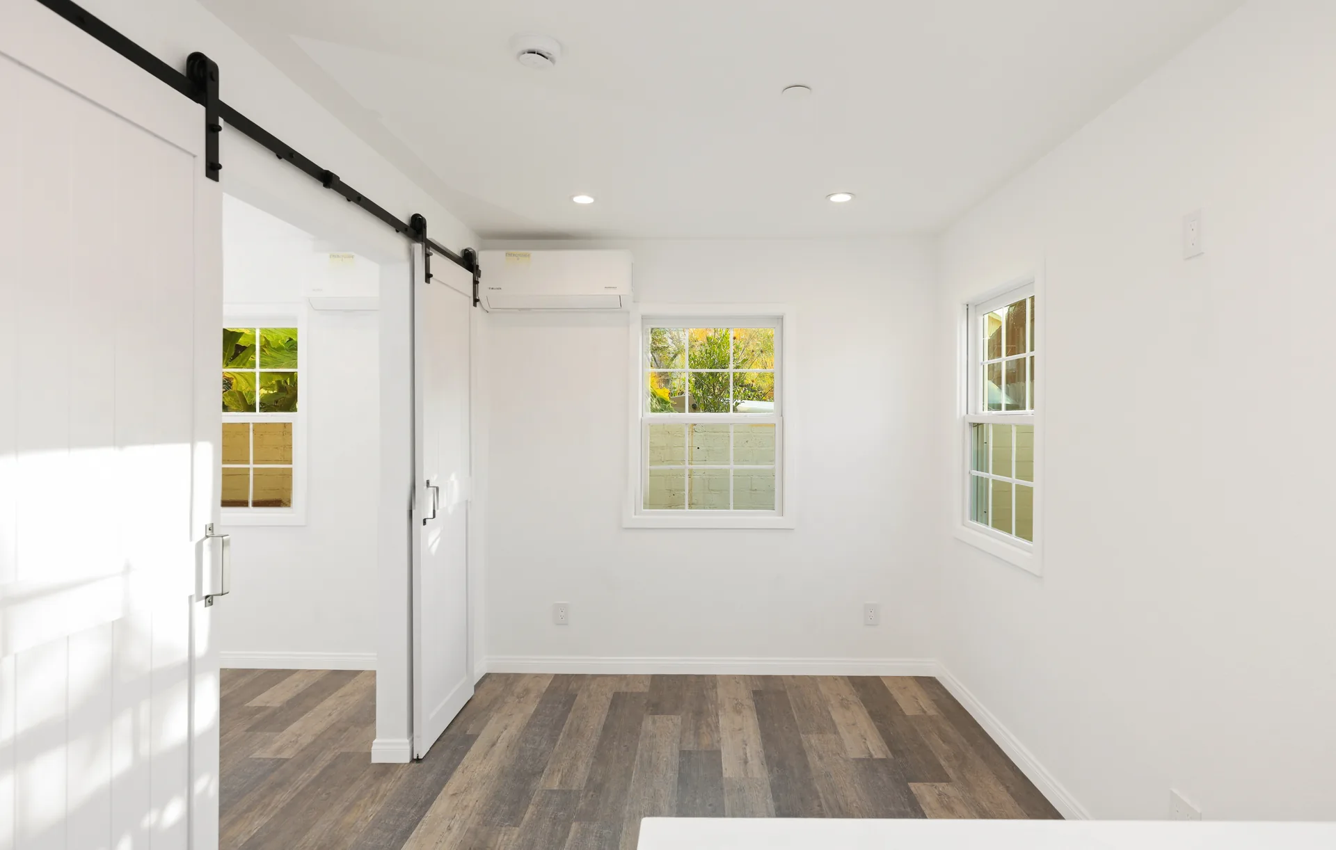 Attached ADU — bedroom behind the barn door, Orange, Avorino