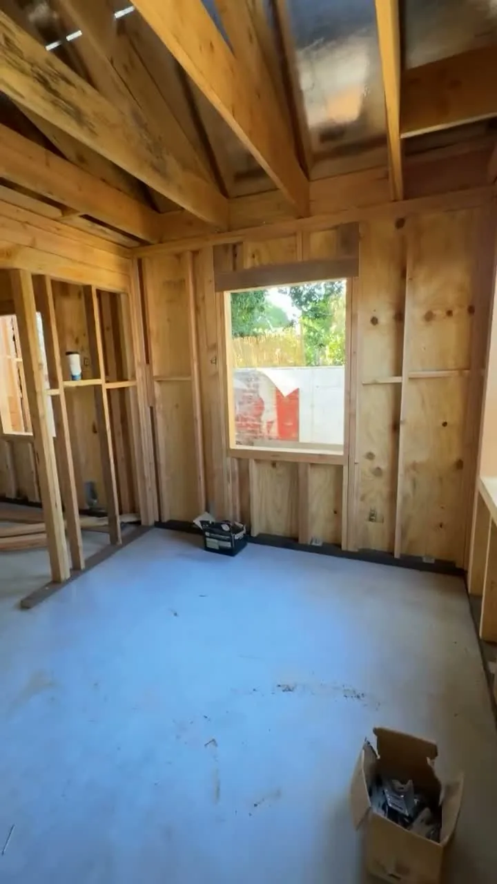 Attached ADU under construction — sheathed wall with the framed window opening, Orange, Avorino